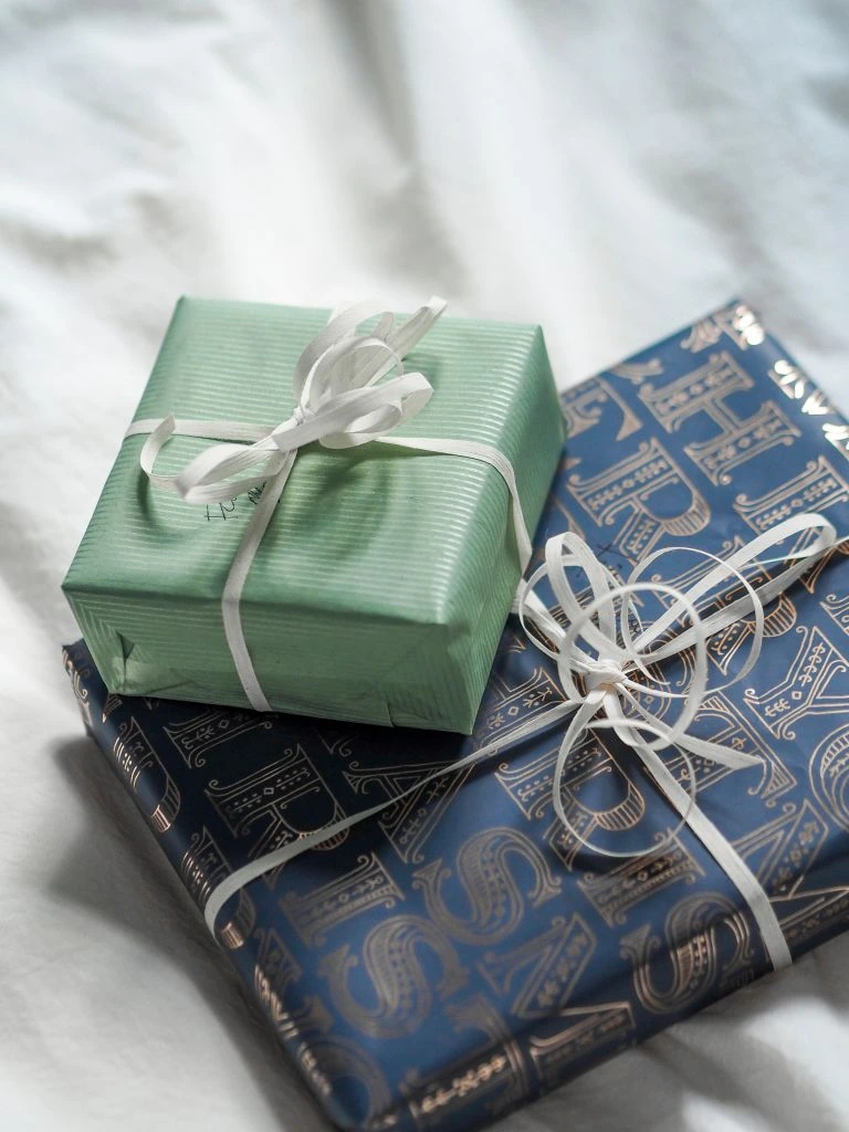 A pair of Seaport gift cards resting against a linen notebook, in physical and digital presentations.
