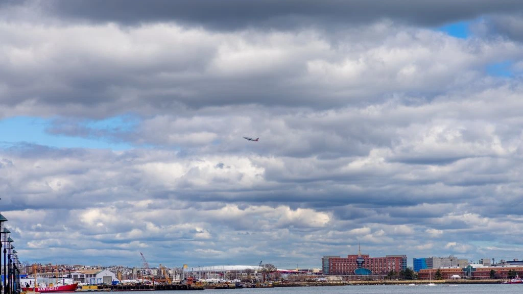 Boston Seaport waterfront at golden hour, viewed from the boardwalk near 487 Seaport Boulevard